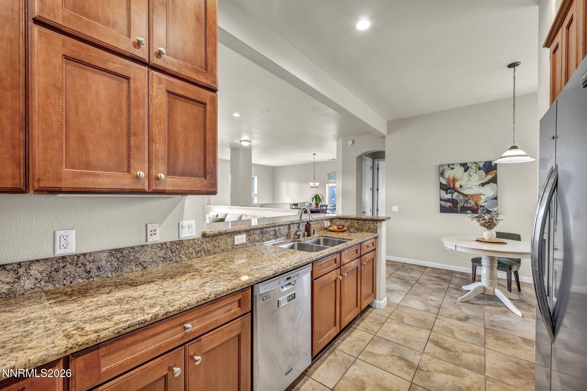 9900 Wilbur May Parkway, Unit 2405 Reno, NV 89521 - Photo 41 of 81 a kitchen with granite countertop a sink a stove and a wooden cabinets