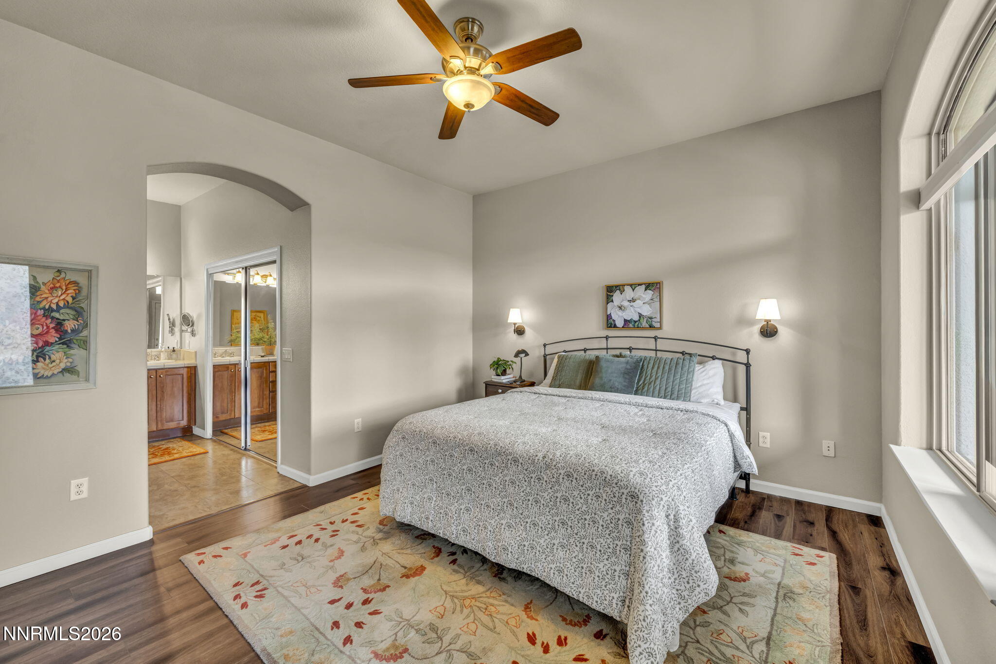 9900 Wilbur May Parkway, Unit 2405 Reno, NV 89521 - Photo 52 of 81 a bedroom with a bed and a chandelier