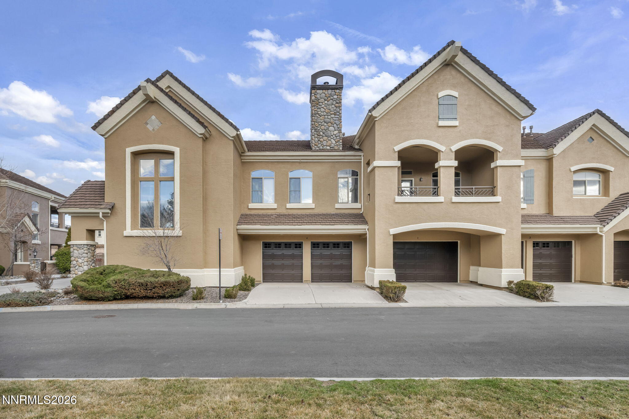 9900 Wilbur May Parkway, Unit 2405 Reno, NV 89521 - Photo 6 of 81 a front view of a house with a yard and garage
