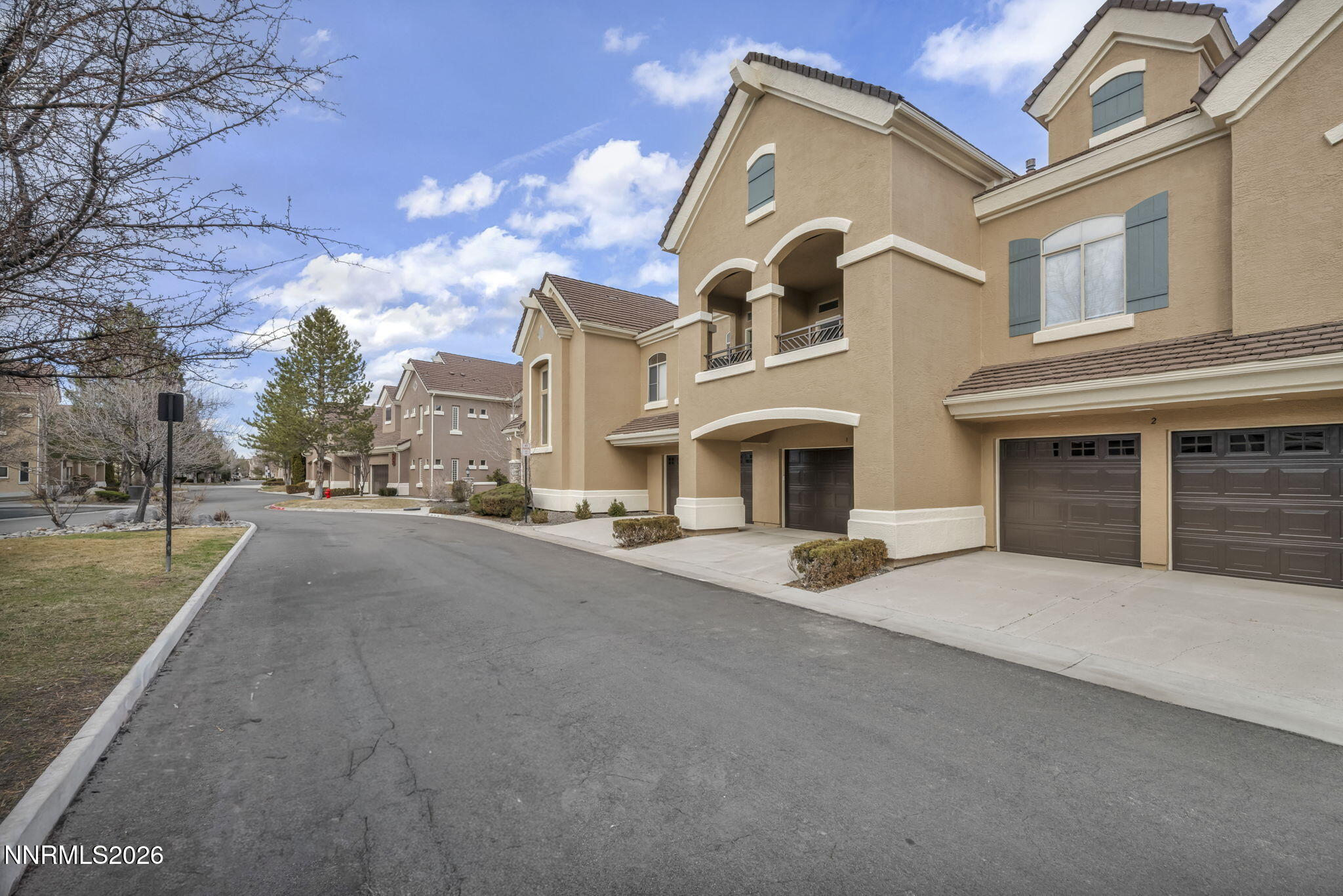 9900 Wilbur May Parkway, Unit 2405 Reno, NV 89521 - Photo 10 of 81 a front view of a house with yard and parking