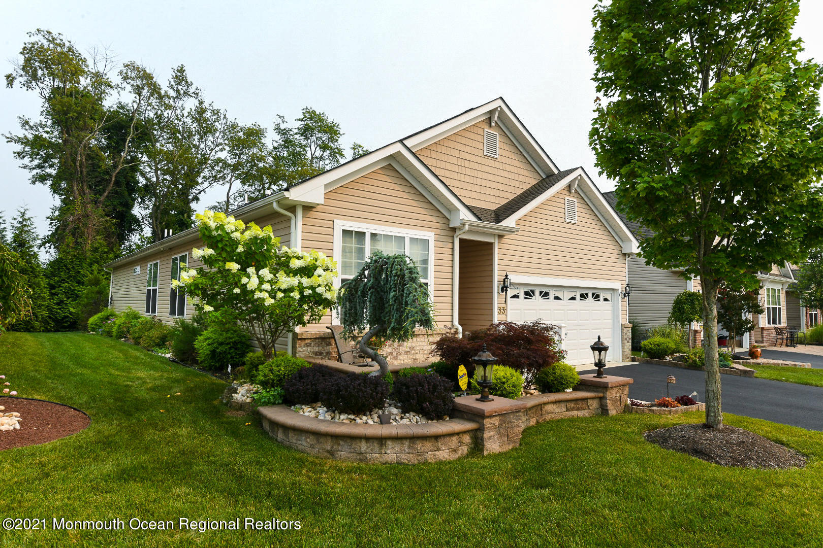 33 Comtois Road Manalapan, NJ 07726 - Photo 2 of 26 a front view of house with a garden and patio