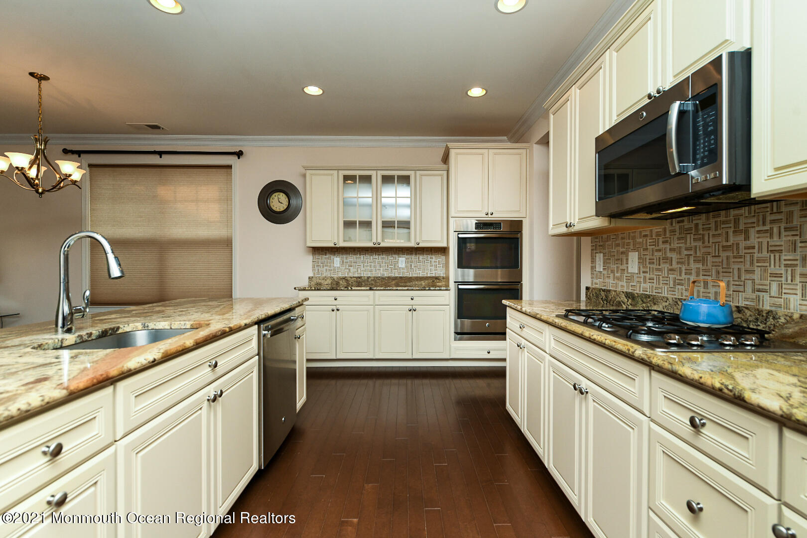 33 Comtois Road Manalapan, NJ 07726 - Photo 11 of 26 a kitchen with stainless steel appliances granite countertop a sink stove and microwave