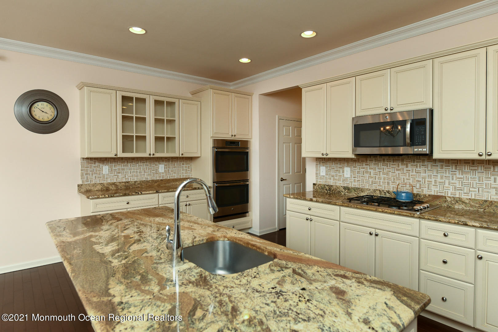 33 Comtois Road Manalapan, NJ 07726 - Photo 13 of 26 a kitchen with stainless steel appliances granite countertop a sink a stove and a microwave