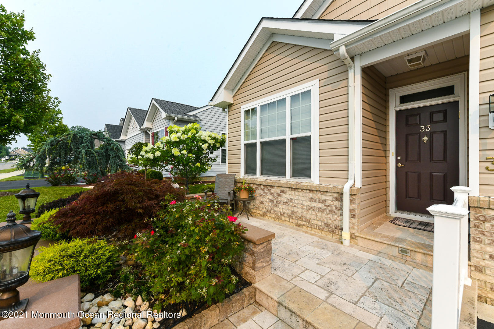 33 Comtois Road Manalapan, NJ 07726 - Photo 3 of 26 a house with flowers in front of it