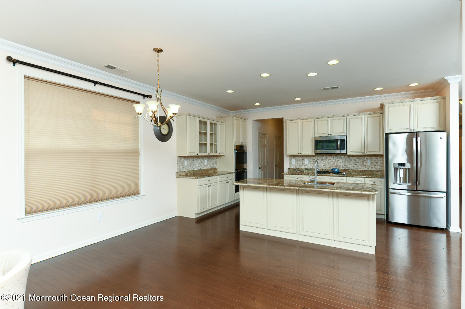 33 Comtois Road Manalapan, NJ 07726 - Photo 9 of 26 a large kitchen with stainless steel appliances granite countertop a refrigerator a oven and a wooden floors