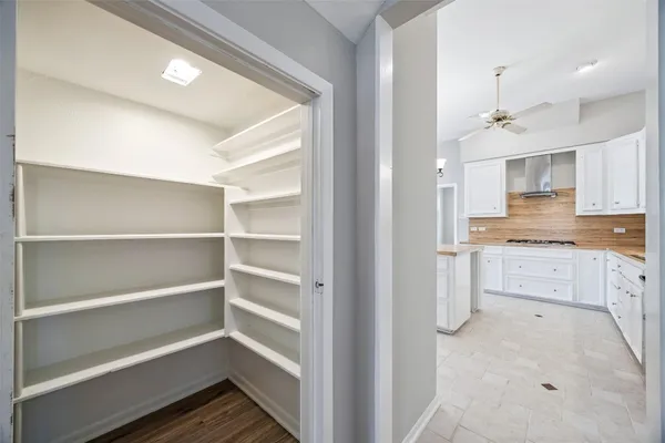 a large kitchen with kitchen island a large counter top space a sink appliances and cabinets