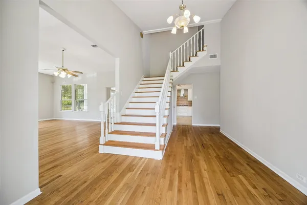 a view of entryway and hall with wooden floor