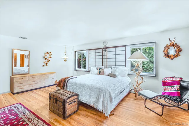 a bed room with a bed and a chair