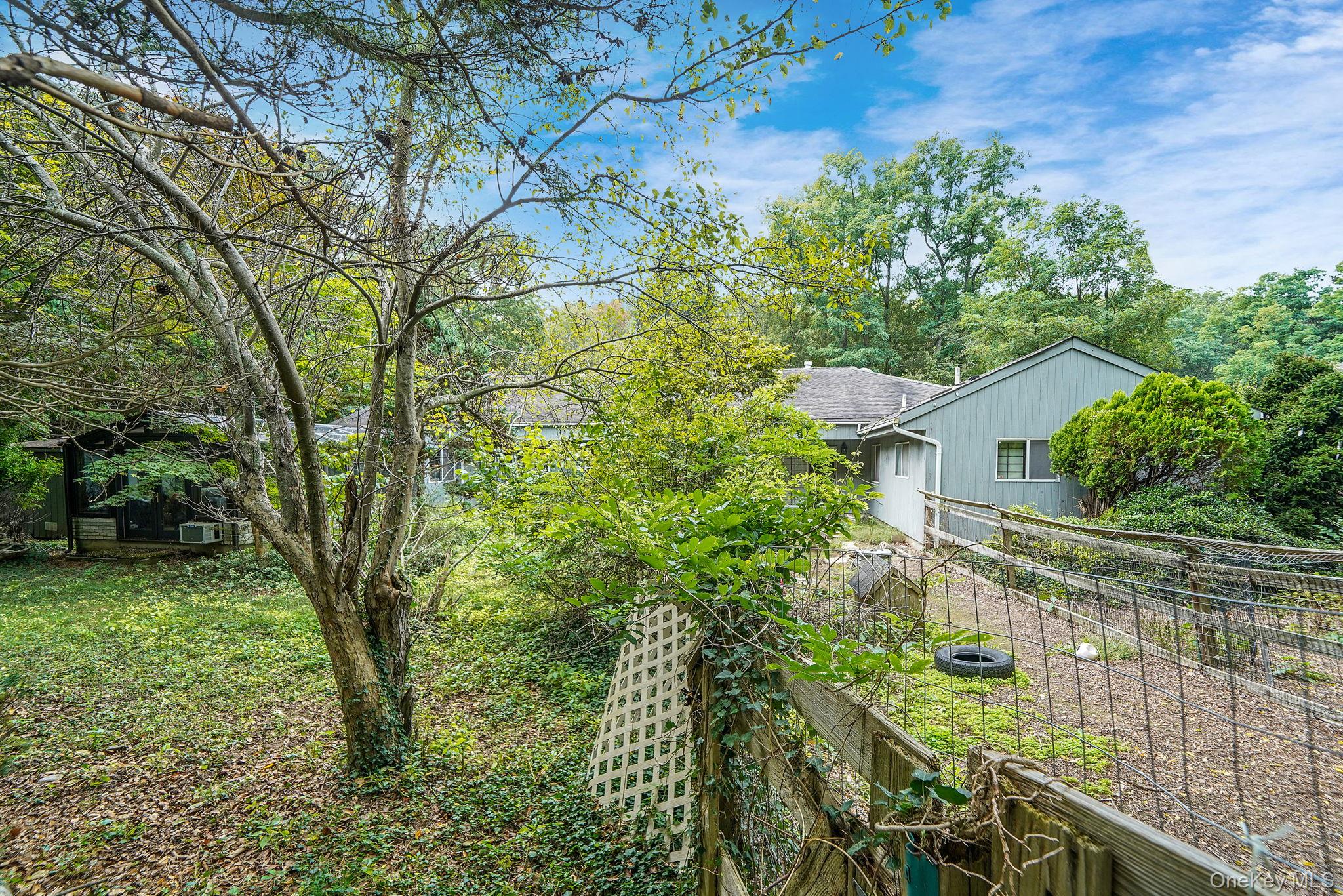271 Bread And Cheese Hollow Road Northport, NY 11768 - Photo 31 of 32 a view of a house with a tree