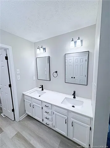 a bathroom with a double vanity sink mirror and