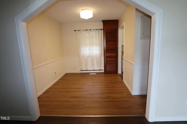 a view of hallway with wooden floor