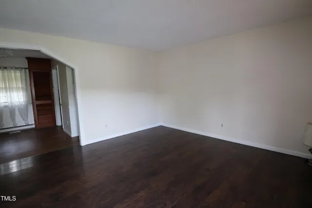 a view of an empty room and wooden floor