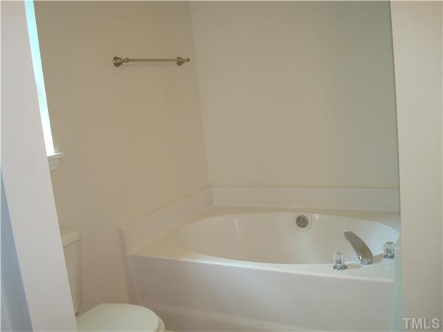 2332 Spruce Shadows Lane Raleigh, NC 27614 - Photo 8 of 11 a white bath tub sitting next to a toilet
