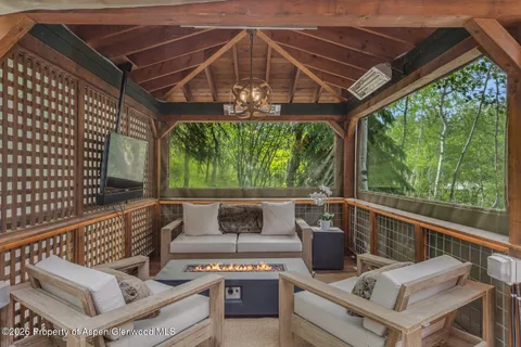 a view of a roof deck with couches and wooden floor