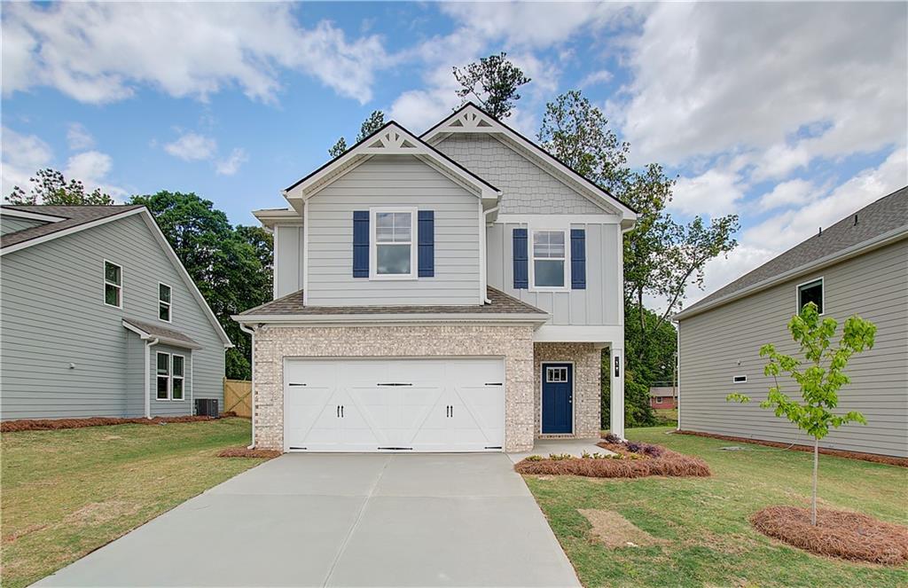 117 Alpine Road Fairburn, GA 30213 - Photo 1 of 29 a front view of a house with a yard and garage