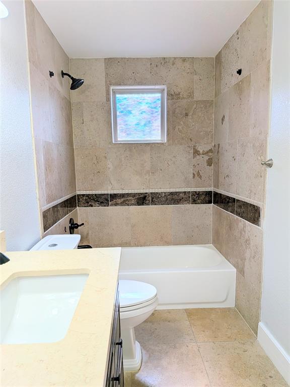 608 Holcomb Road Dallas, TX 75217 - Photo 16 of 23 a bathroom with a tub a sink and a shower