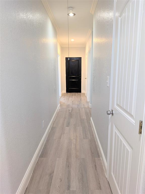 608 Holcomb Road Dallas, TX 75217 - Photo 20 of 23 a view of a hallway with wooden floor