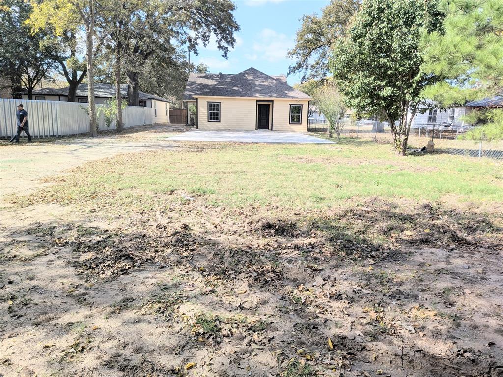 608 Holcomb Road Dallas, TX 75217 - Photo 22 of 23 a front view of a house with a yard and trees