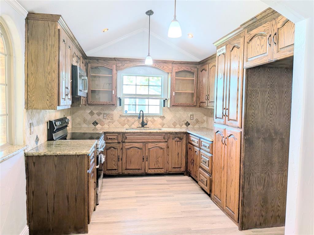 608 Holcomb Road Dallas, TX 75217 - Photo 6 of 23 a kitchen with stainless steel appliances granite countertop a sink stove and refrigerator