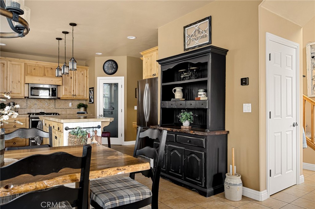 28111 Grenoble Drive Lake Arrowhead, CA 92352 - Photo 16 of 40 a view of a kitchen and dining area with chandelier