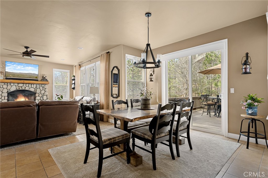 28111 Grenoble Drive Lake Arrowhead, CA 92352 - Photo 20 of 40 a view of a dining room and livingroom with furniture wooden floor a chandelier