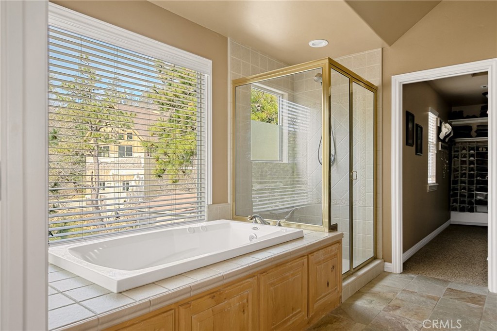28111 Grenoble Drive Lake Arrowhead, CA 92352 - Photo 26 of 40 a bathroom with a bathtub and a shower