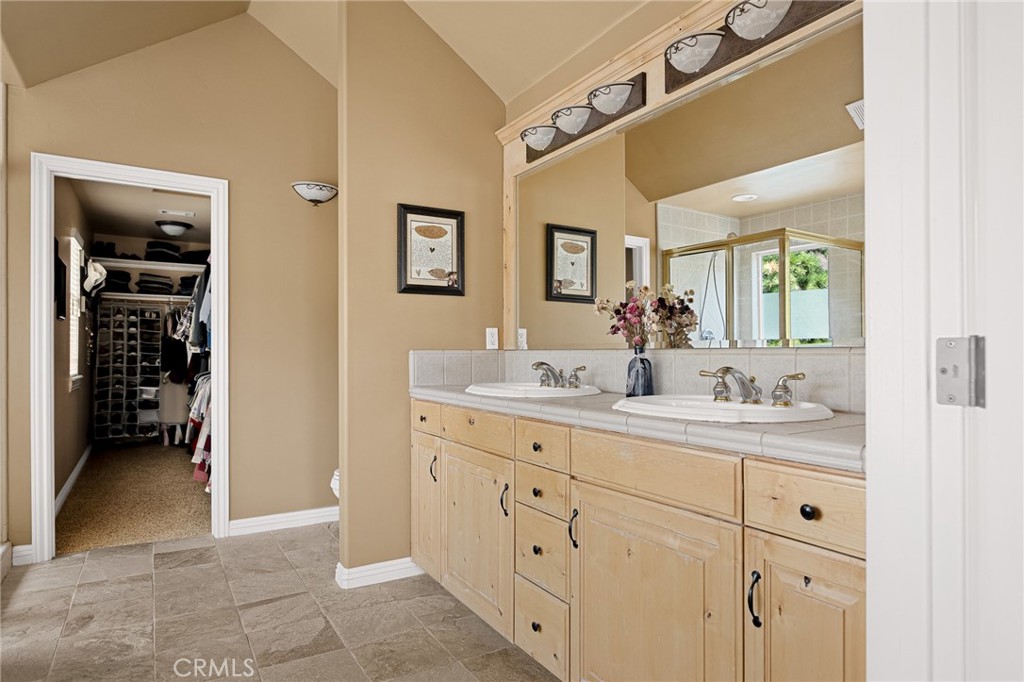 28111 Grenoble Drive Lake Arrowhead, CA 92352 - Photo 27 of 40 a bathroom with a double vanity sink and a mirror