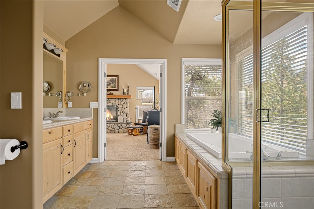 28111 Grenoble Drive Lake Arrowhead, CA 92352 - Photo 28 of 40 a large bathroom with a glass door shower and sink