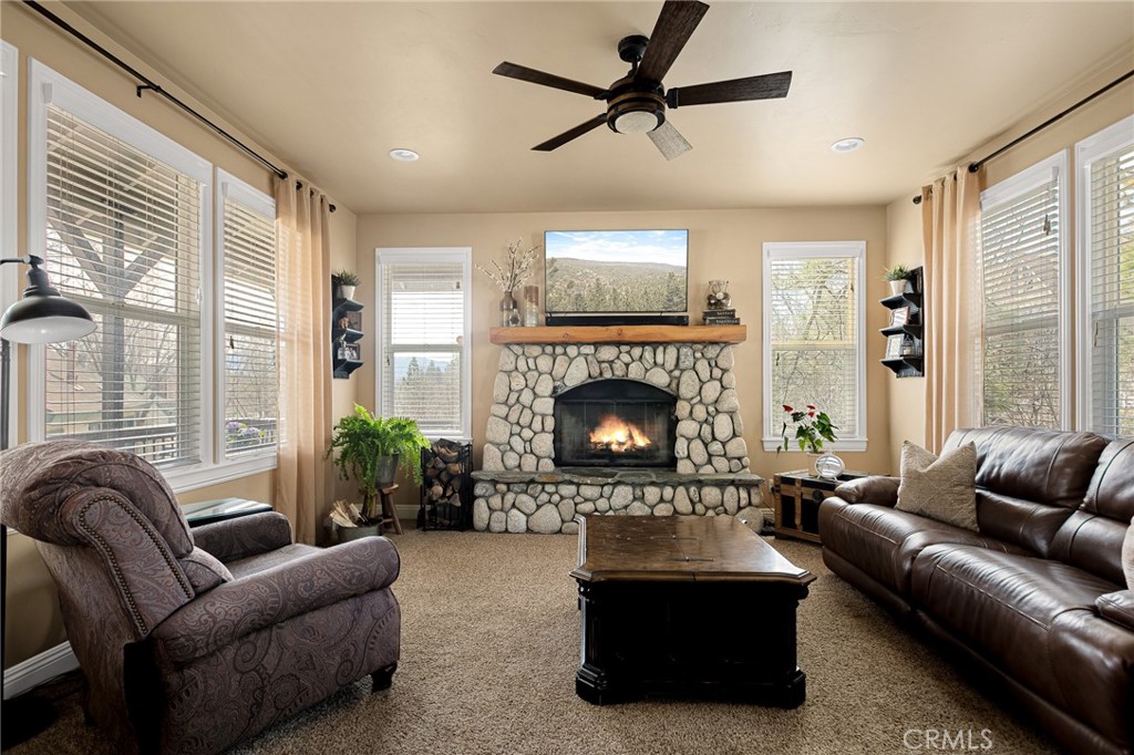 28111 Grenoble Drive Lake Arrowhead, CA 92352 - Photo 3 of 40 a living room with furniture and a fireplace