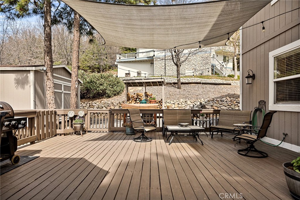 28111 Grenoble Drive Lake Arrowhead, CA 92352 - Photo 33 of 40 a balcony with wooden floor table and chairs