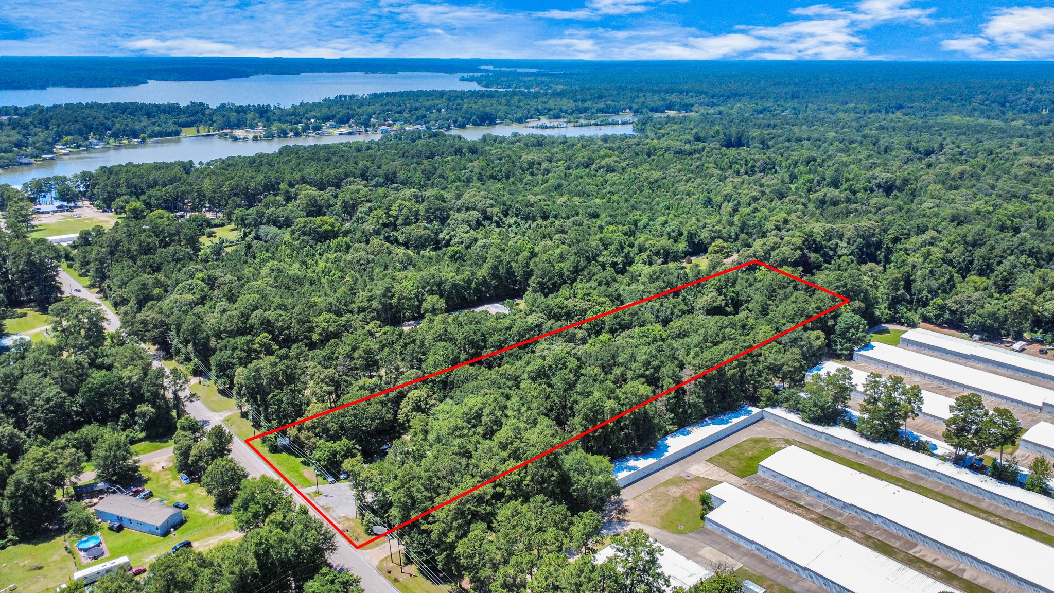 a view of a yard with a lot of flower plants and wooden fence