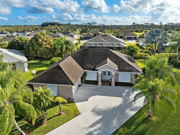 an aerial view of a house with a yard