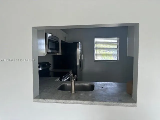 a bathroom with a sink a mirror and a window