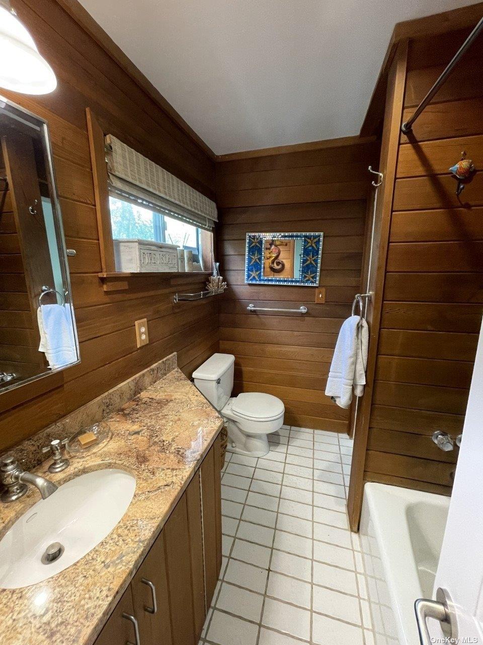 275 Wilmot Road Ocean Beach, NY 11770 - Photo 11 of 19 a bathroom with a granite countertop sink a mirror and a shower