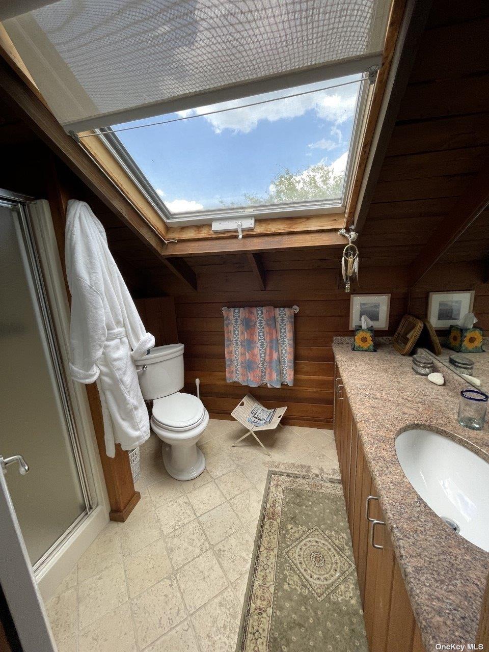275 Wilmot Road Ocean Beach, NY 11770 - Photo 12 of 19 a bathroom with a granite countertop toilet sink and mirror