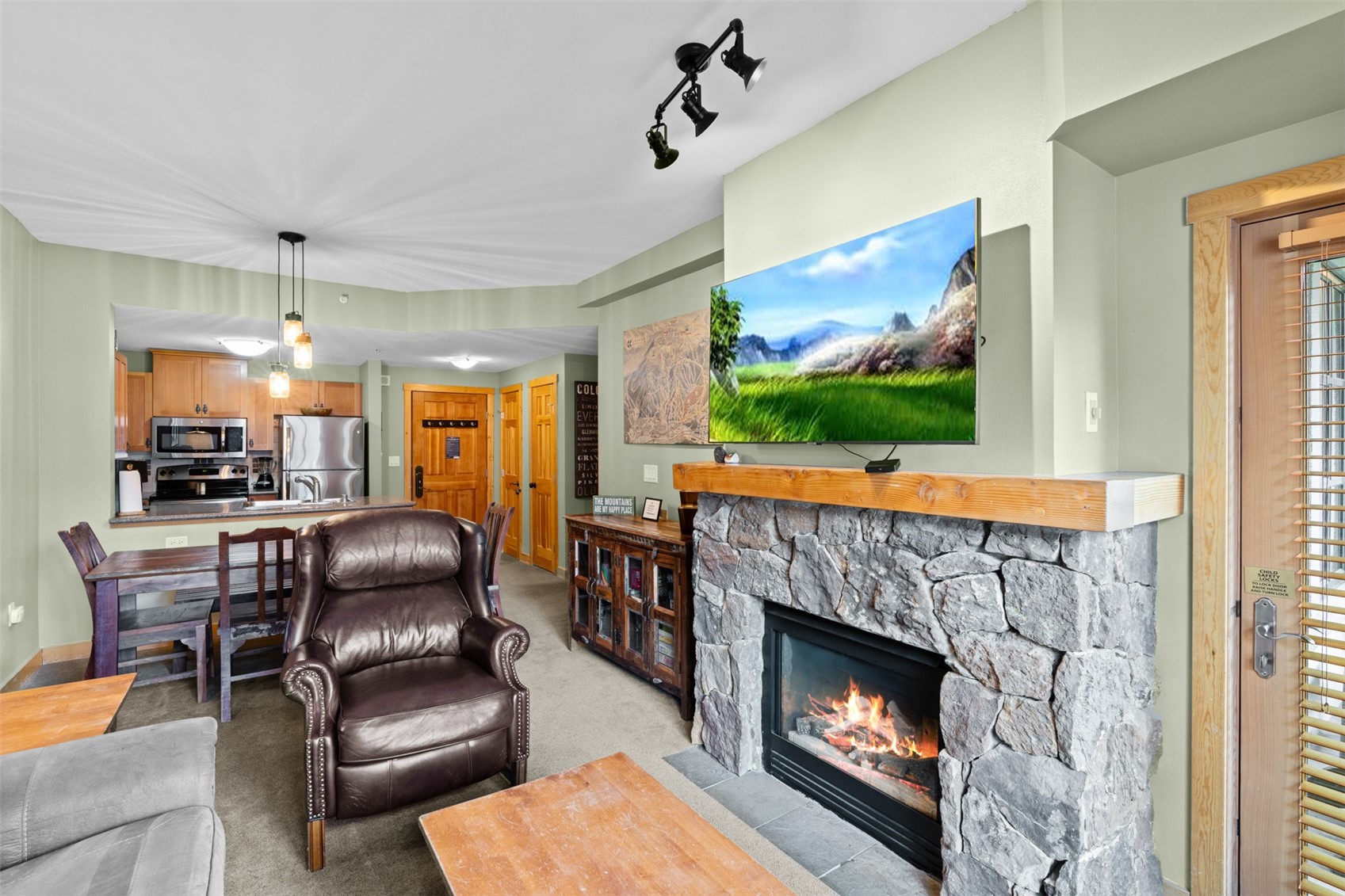 910 Copper Road, Unit 308 Frisco, CO 80443 - Photo 5 of 42 Living room with light colored carpet and a stone fireplace