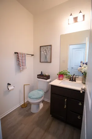 a bathroom with a toilet sink and mirror