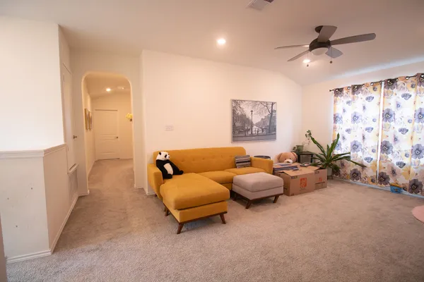 a living room with furniture and a chandelier