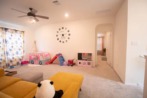 a bedroom with furniture and a flat screen tv