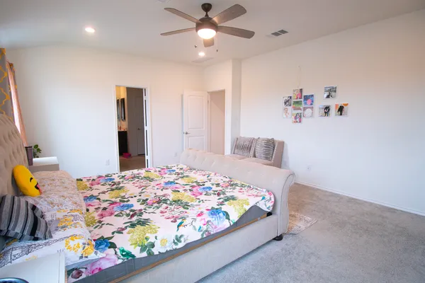 a bedroom with bed and wooden floor