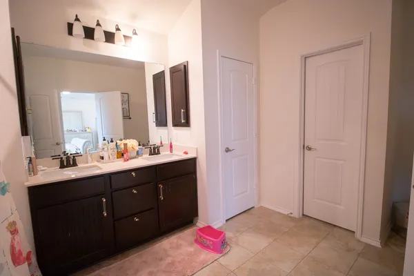a bathroom with a sink vanity and mirror