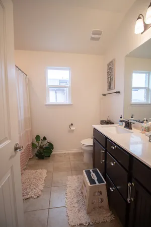 a bathroom with a double vanity sink and a mirror