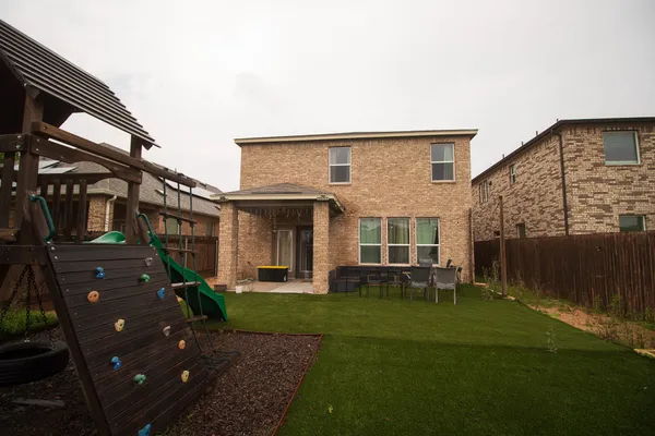 a front view of house with a garden
