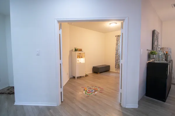 a view of a room with wooden floor and bedroom