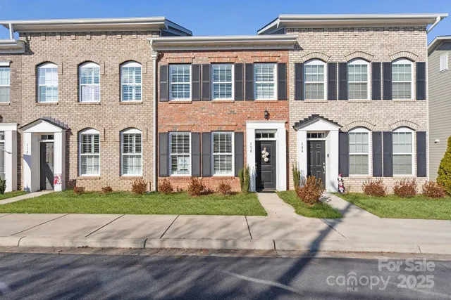 a front view of a house with a garden and plants