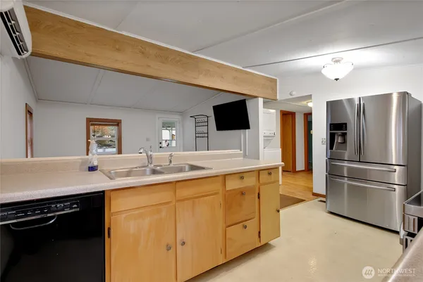 a kitchen with a sink stainless steel appliances and cabinets