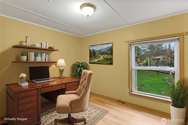 a view of a workspace with furniture and a window