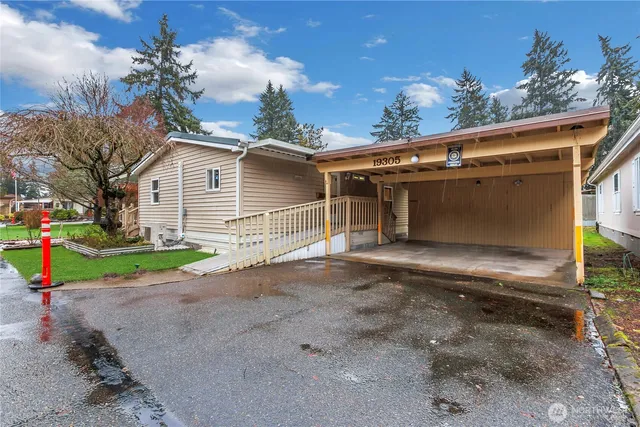 a view of a house with a yard and garage