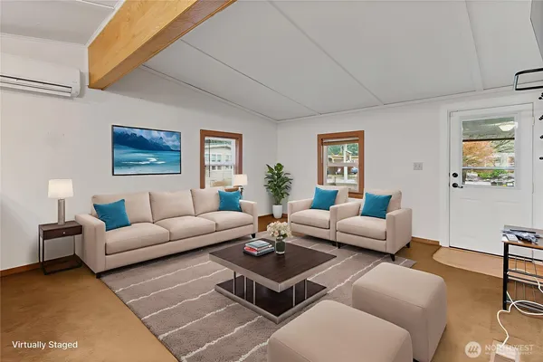 a living room with furniture rug and window