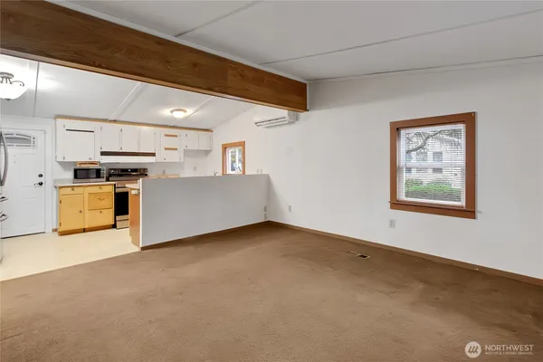 a view of an empty room with a kitchen